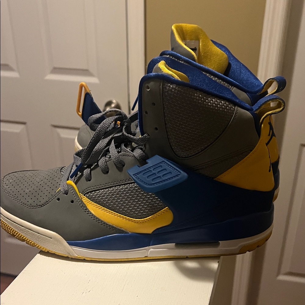 Gray and Yellow High-Top Nike air Jordan’s flight Sneakers.